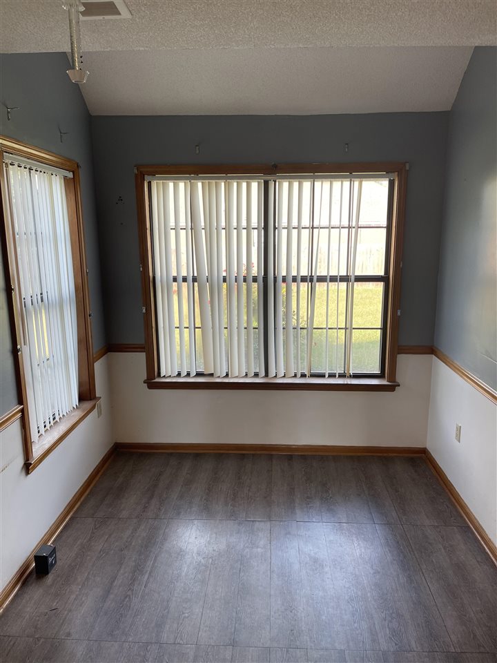 5277 Ross Road Memphis, TN 38141 - Photo 22 of 25 a view of an empty room with wooden floor and a window
