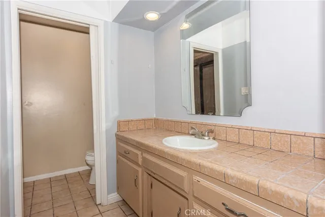 a bathroom with a sink a vanity and a mirror