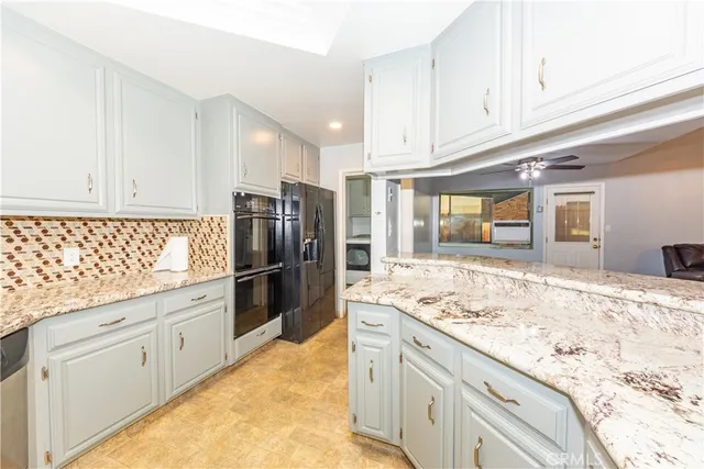 a kitchen with refrigerator and cabinets