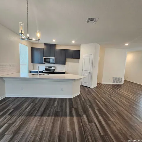 a kitchen with stainless steel appliances a refrigerator sink and microwave
