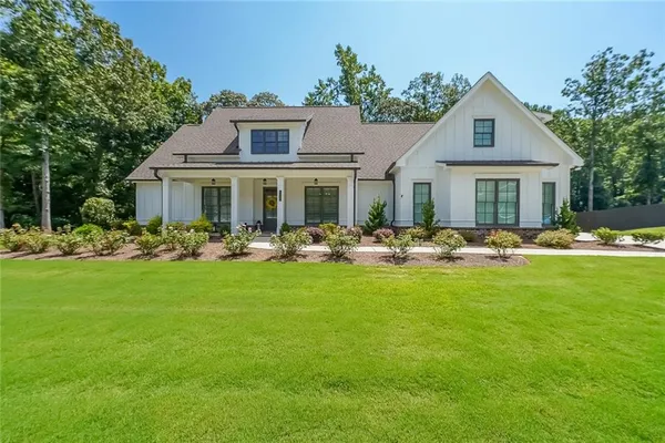 a front view of house with yard and green space