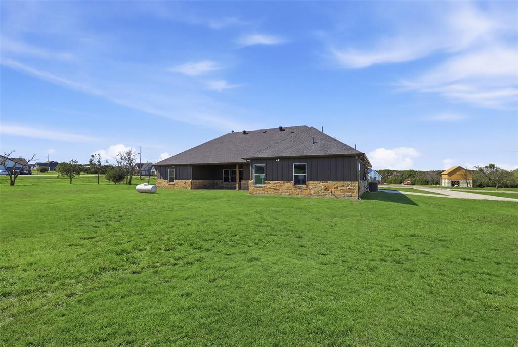 6657 Buffalo Ridge Circle Godley, TX 76044 - Photo 27 of 31 a front view of a house with garden