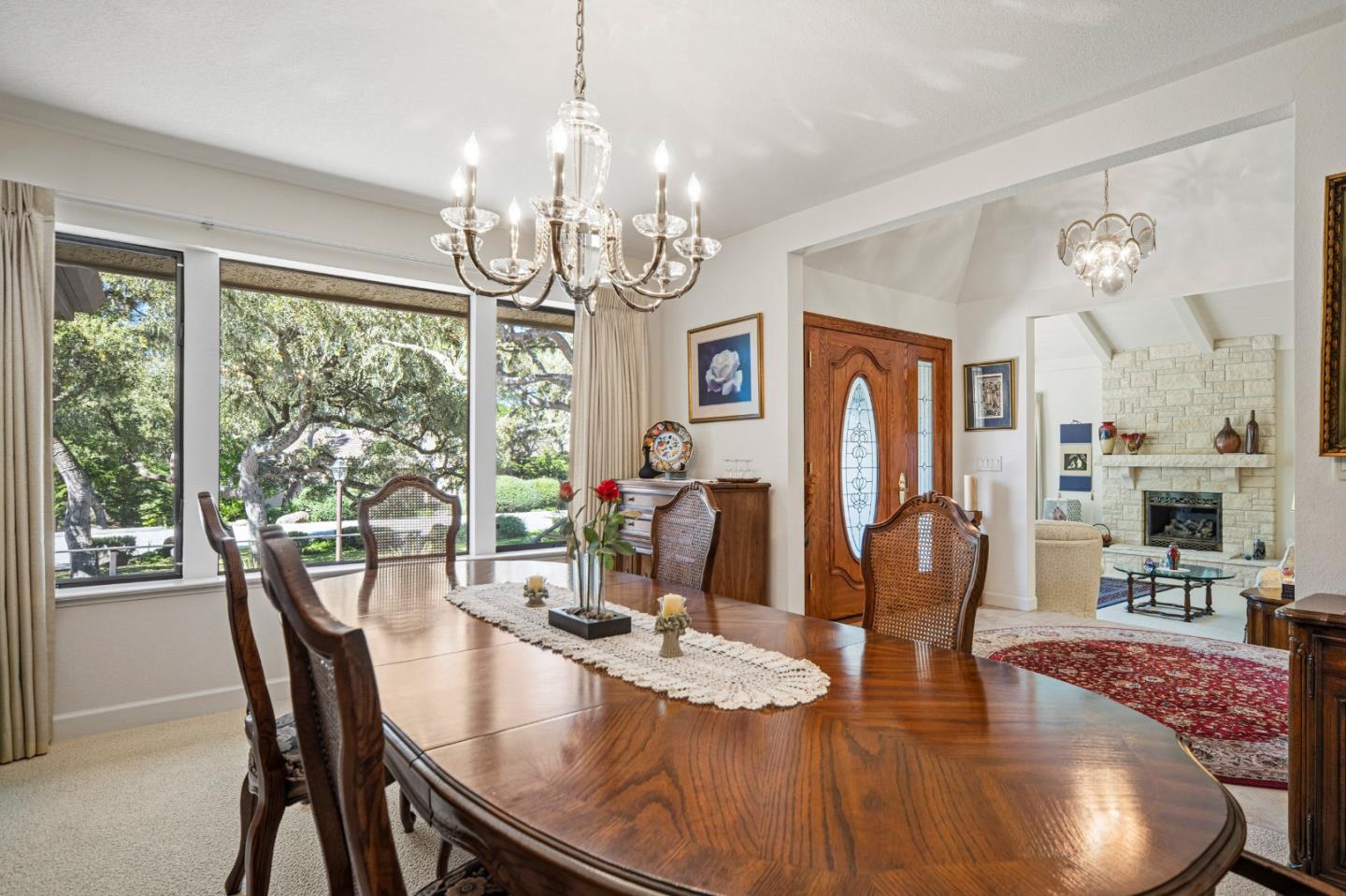 2911 Colton Road Pebble Beach, CA 93953 - Photo 11 of 46 a dining room with wooden floor a chandelier a wooden table and chairs
