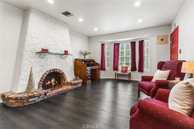 a living room with furniture fireplace and flat screen tv