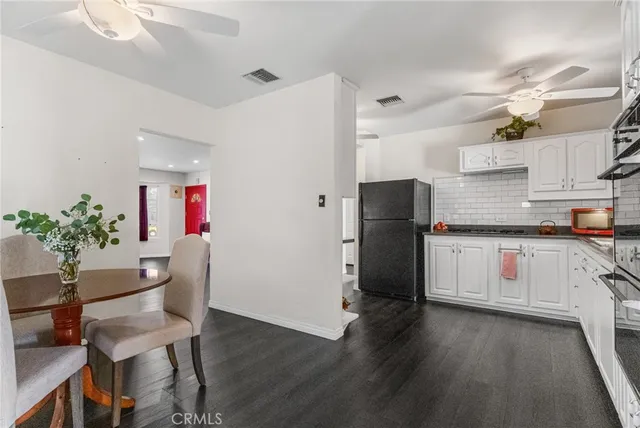 a kitchen with granite countertop white cabinets and stainless steel appliances