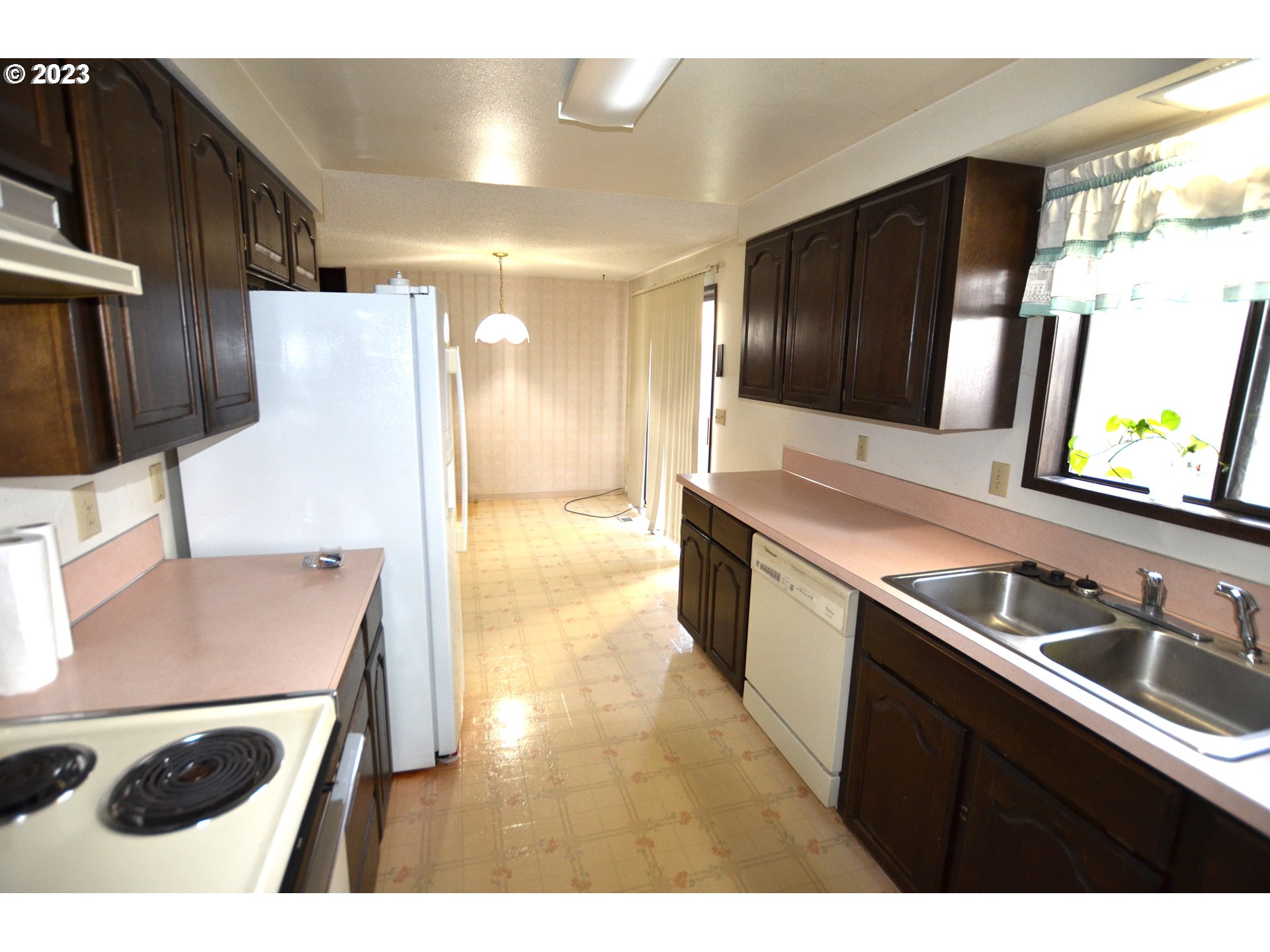 1604 Southwest 22nd Street Pendleton, OR 97801 - Photo 11 of 23 a kitchen with stainless steel appliances kitchen island a sink stove and refrigerator