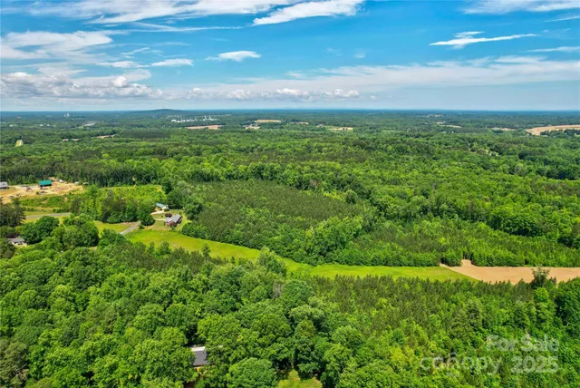 a view of a big yard with lots of green space