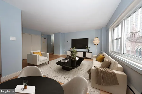 a living room with furniture and a flat screen tv
