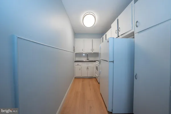 a view of a kitchen with cabinets and stainless steel appliances