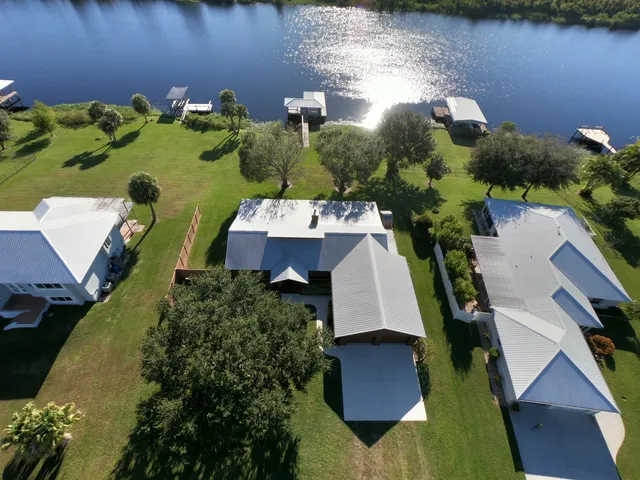 an aerial view of a house with a yard basket ball court and outdoor seating