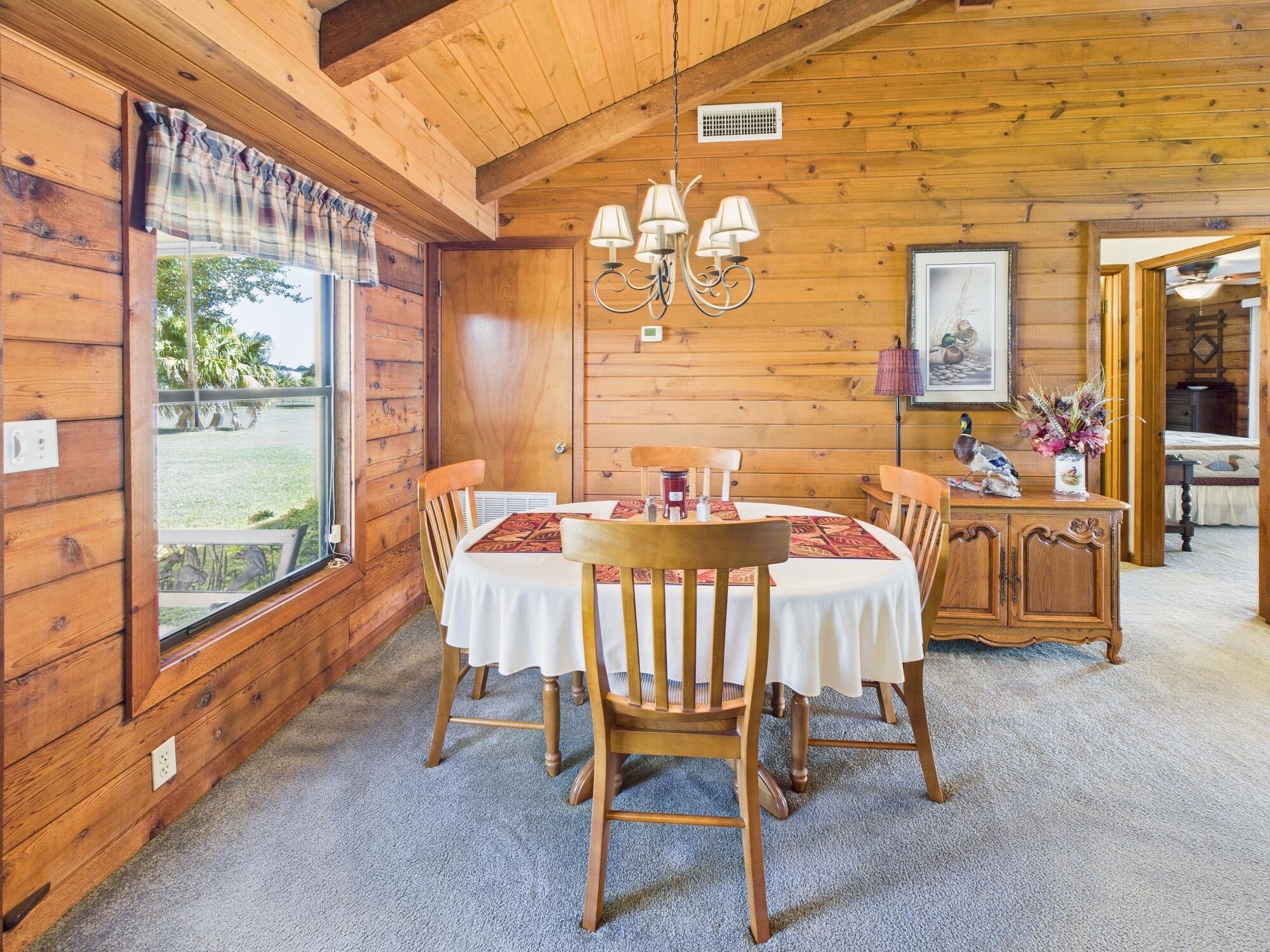 14266 Southwest 144th Parkway Okeechobee, FL 34974 - Photo 11 of 63 a view of a dining room with furniture a chandelier and wooden floor