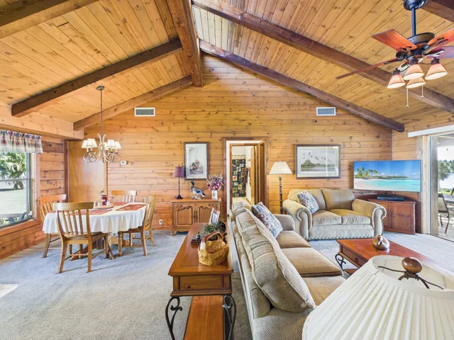 a living room with furniture a fireplace and a table