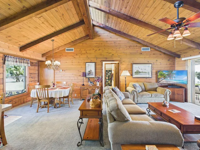 a living room with furniture a fireplace and potted plants