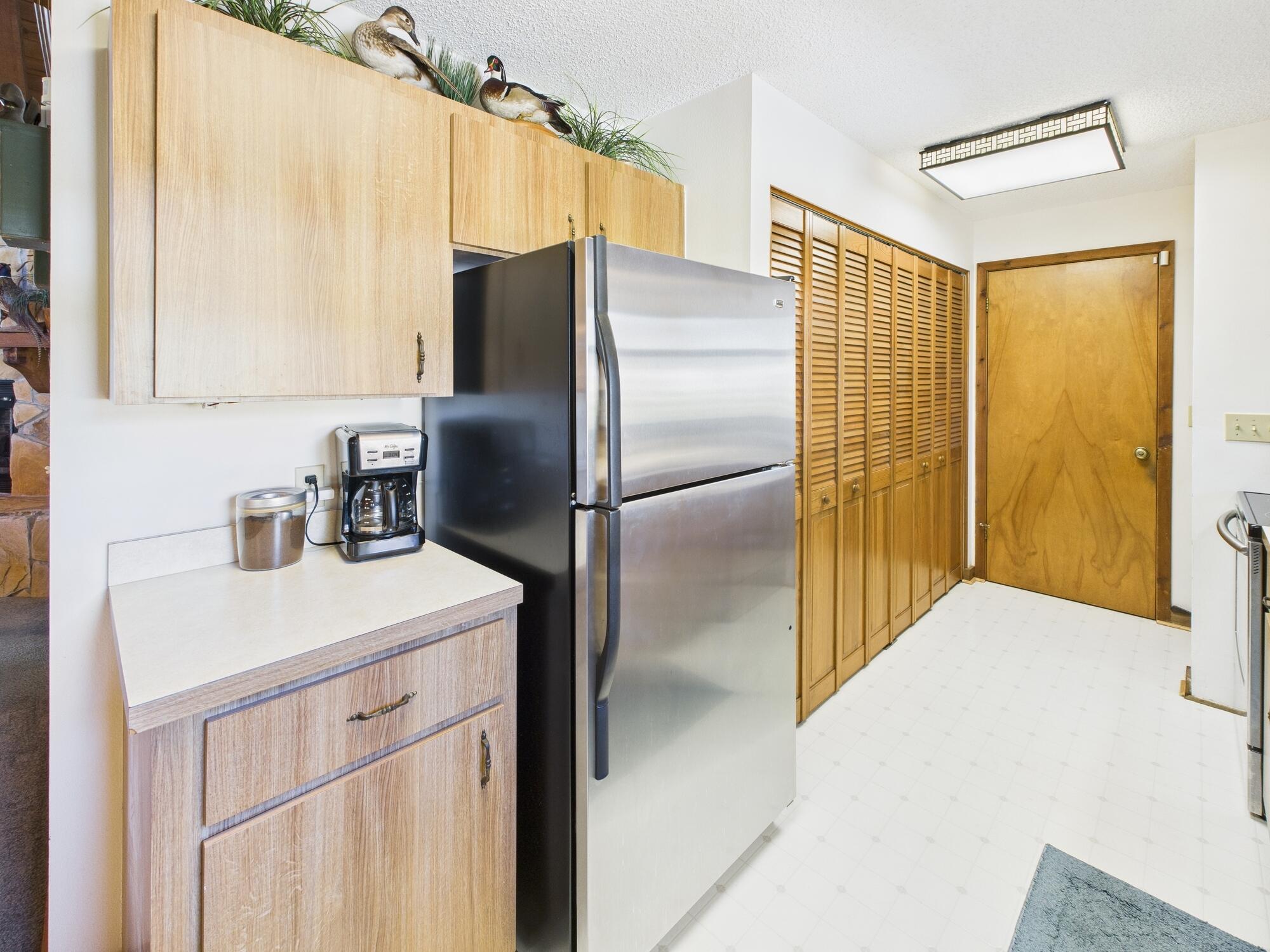 14266 Southwest 144th Parkway Okeechobee, FL 34974 - Photo 17 of 63 a kitchen with a refrigerator a sink and cabinets