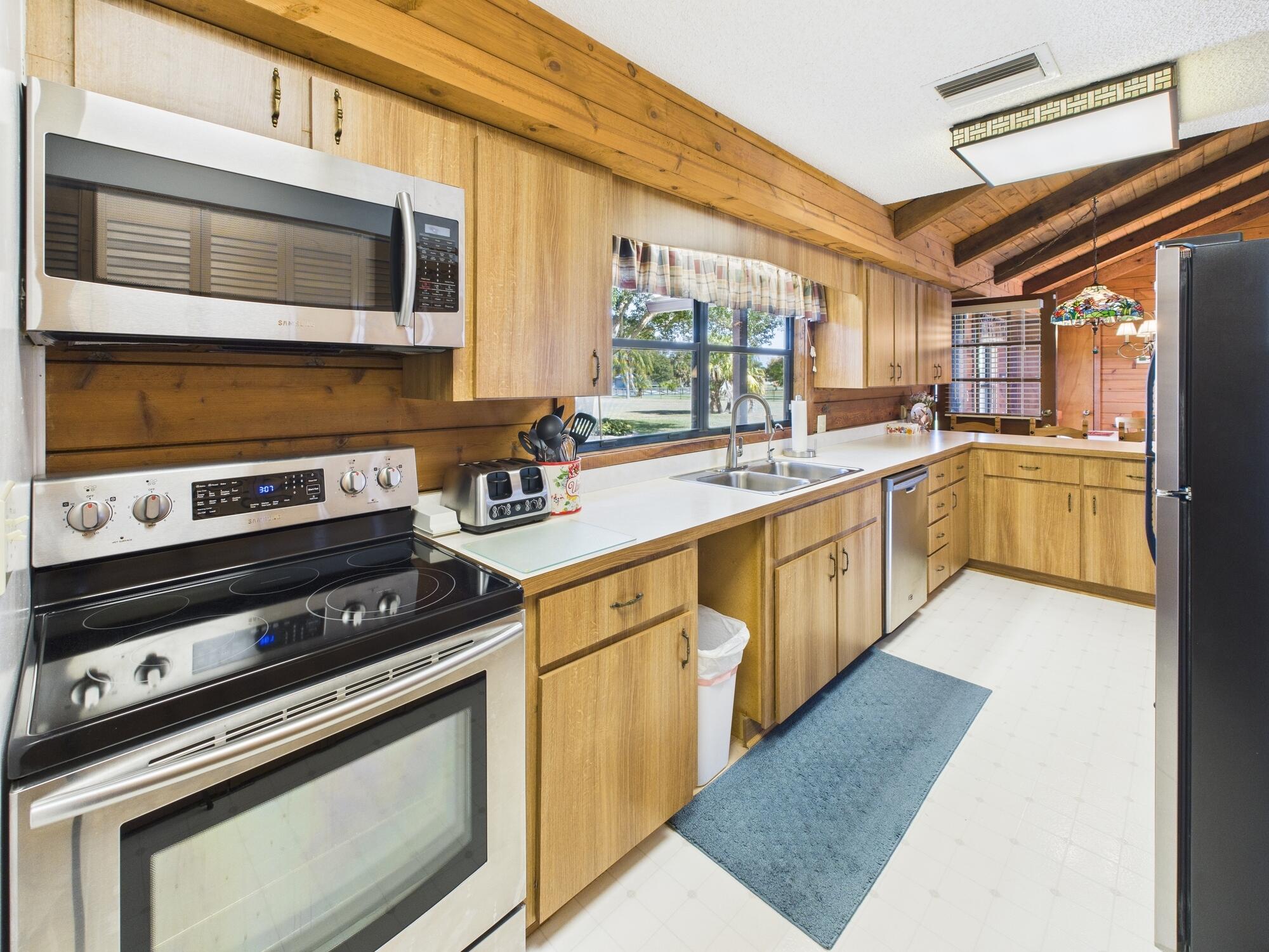 14266 Southwest 144th Parkway Okeechobee, FL 34974 - Photo 19 of 63 a kitchen with stainless steel appliances granite countertop a stove and a microwave