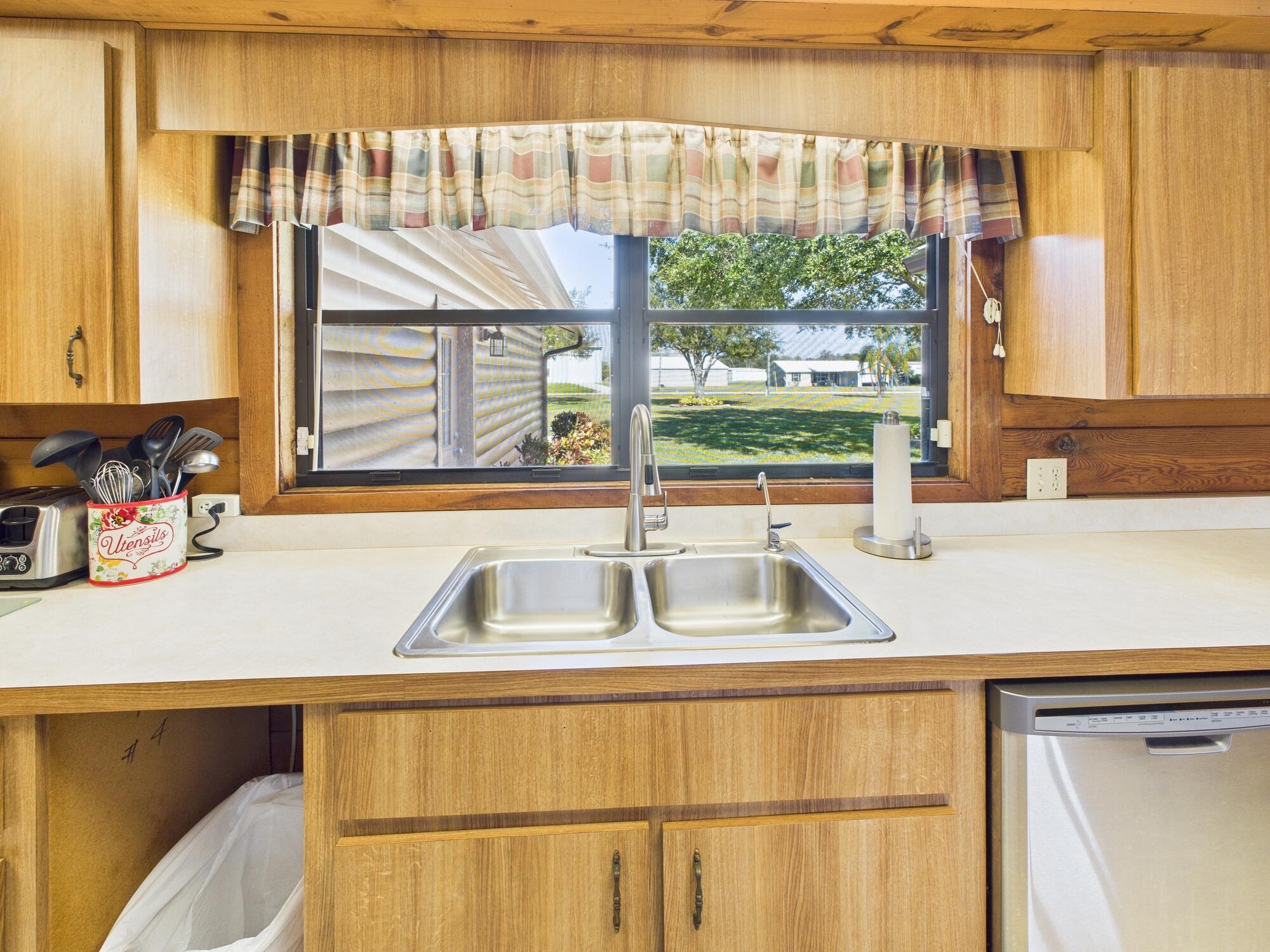 14266 Southwest 144th Parkway Okeechobee, FL 34974 - Photo 20 of 63 a kitchen with a sink and a window