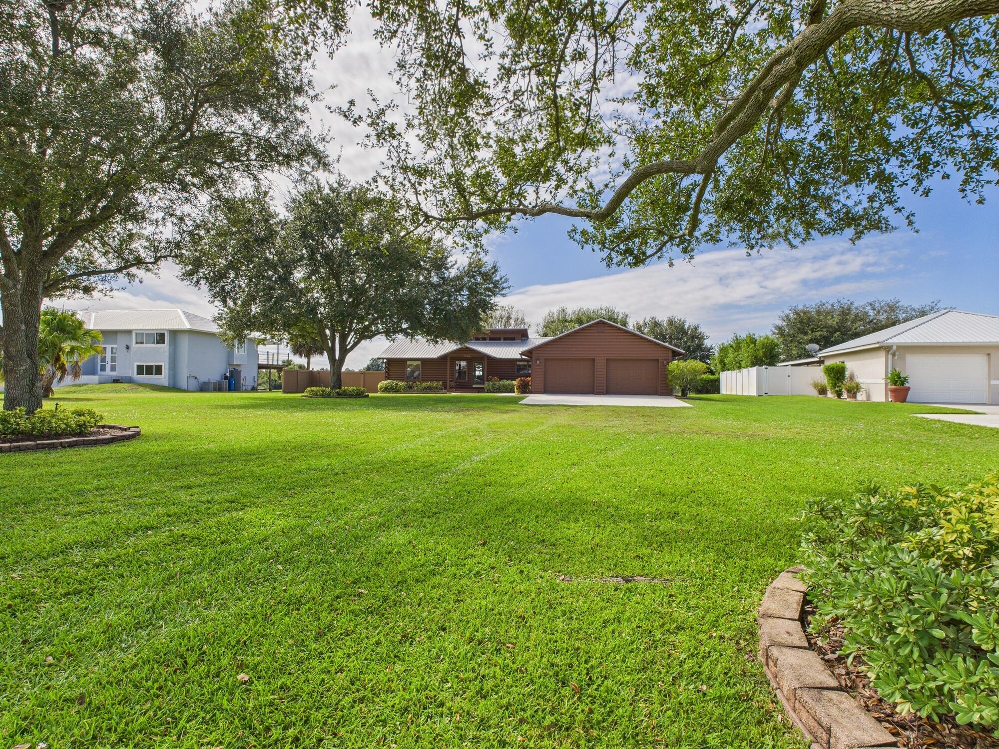 14266 Southwest 144th Parkway Okeechobee, FL 34974 - Photo 2 of 63 a view of a house with a big yard