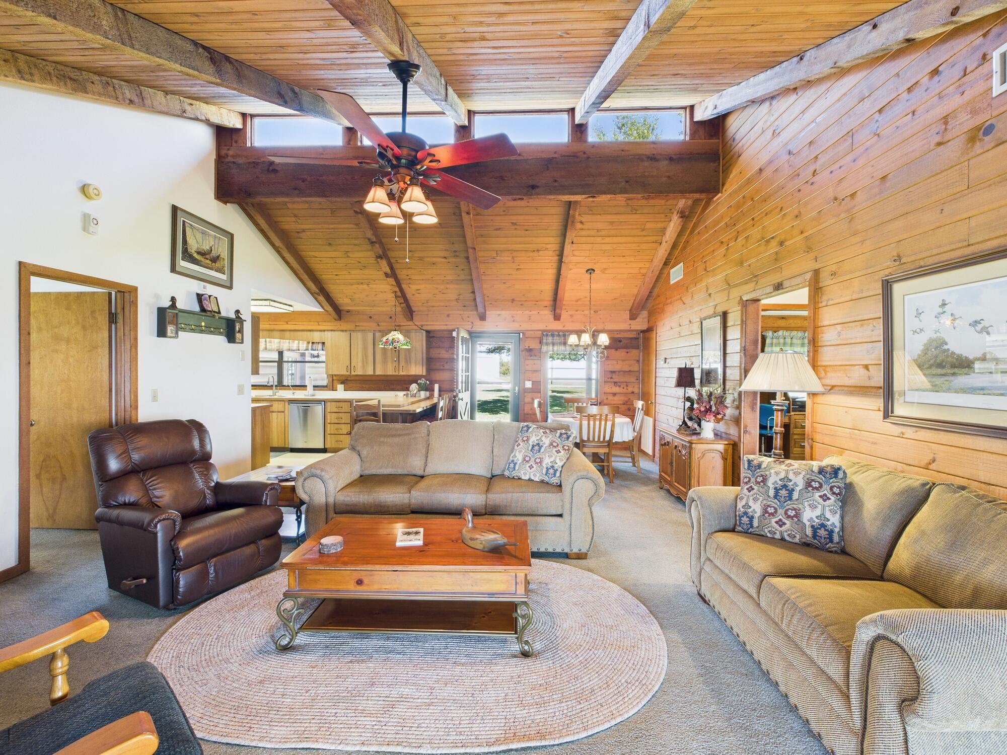 14266 Southwest 144th Parkway Okeechobee, FL 34974 - Photo 22 of 63 a living room with furniture ceiling fan and a rug