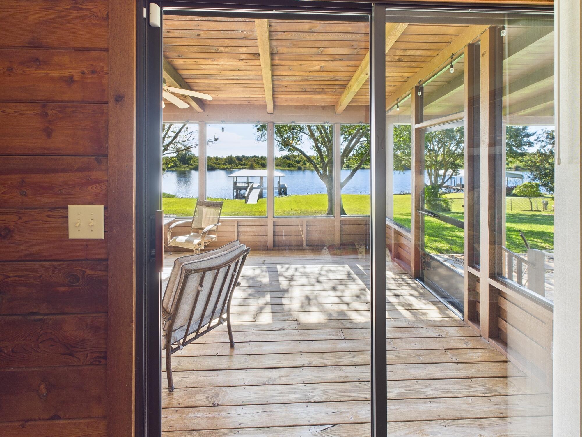 14266 Southwest 144th Parkway Okeechobee, FL 34974 - Photo 26 of 63 a view of a living room and floor to ceiling window
