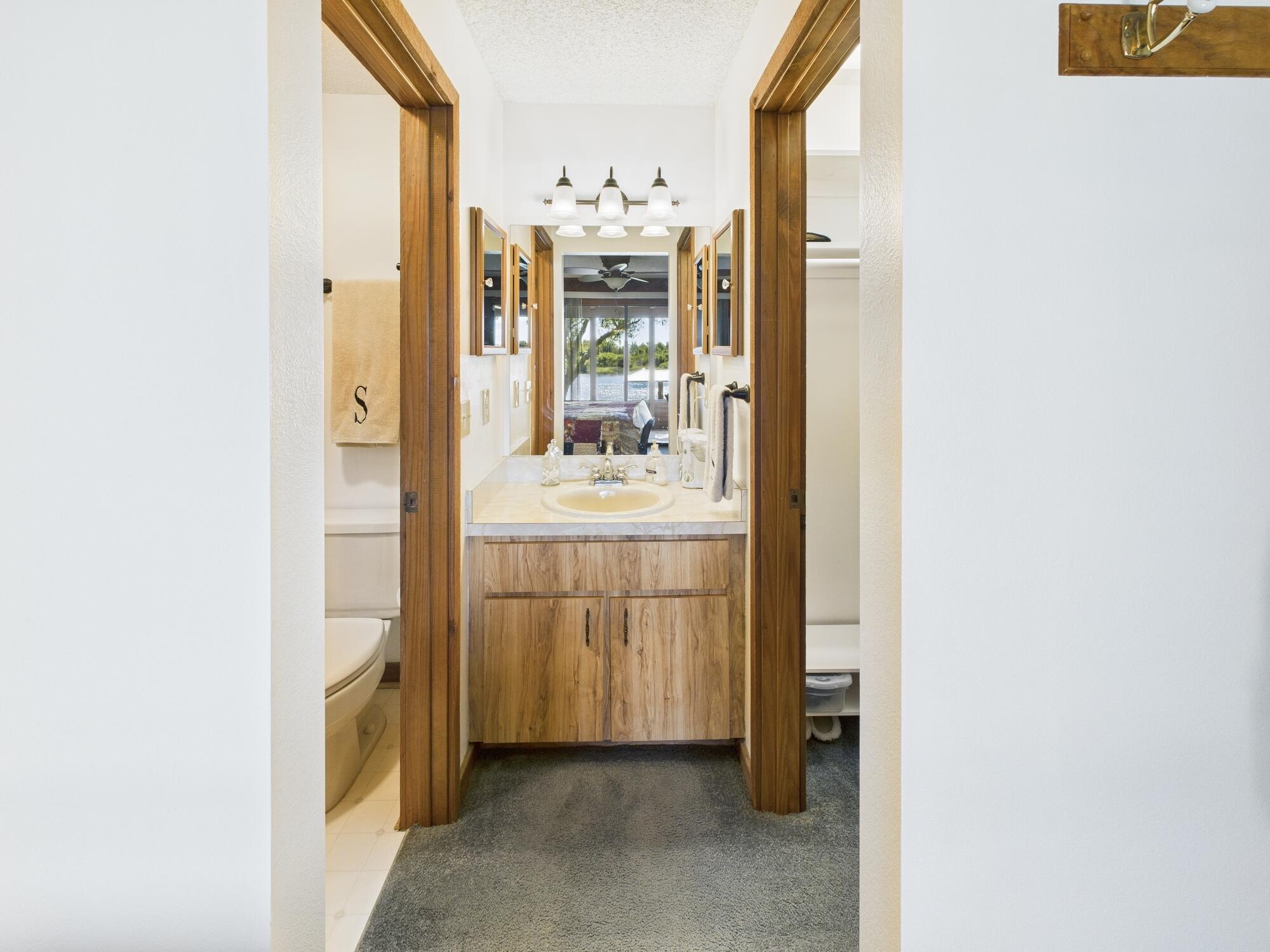 14266 Southwest 144th Parkway Okeechobee, FL 34974 - Photo 27 of 63 a bathroom with a sink and mirror