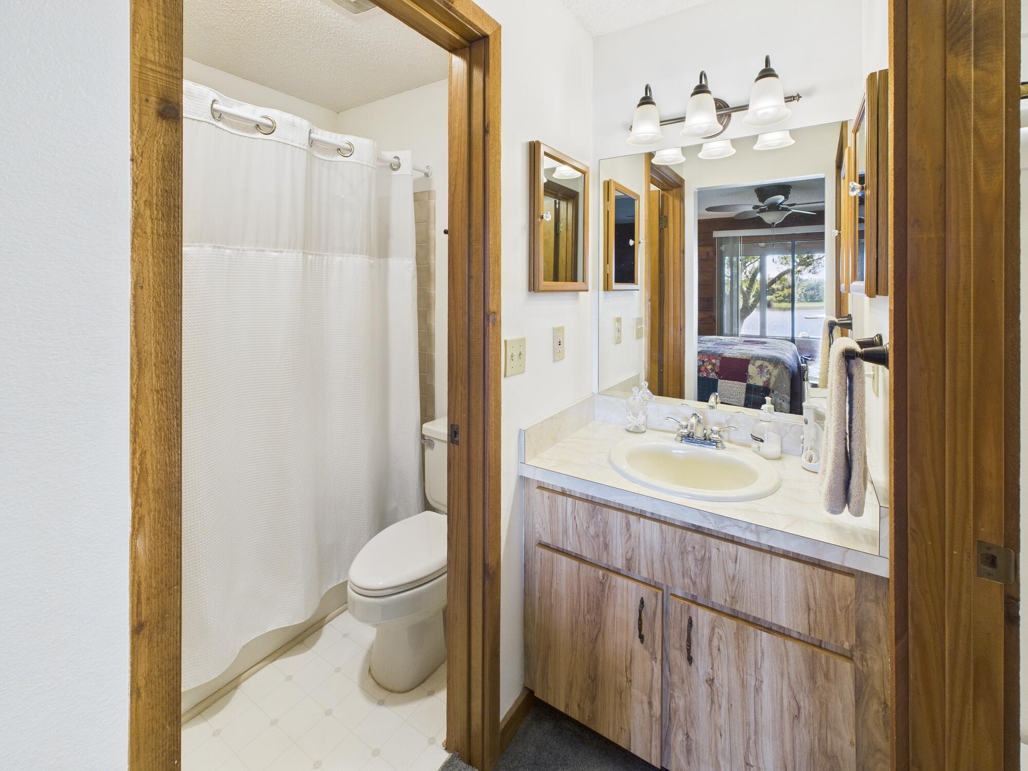 14266 Southwest 144th Parkway Okeechobee, FL 34974 - Photo 28 of 63 a bathroom with a sink a toilet and a mirror
