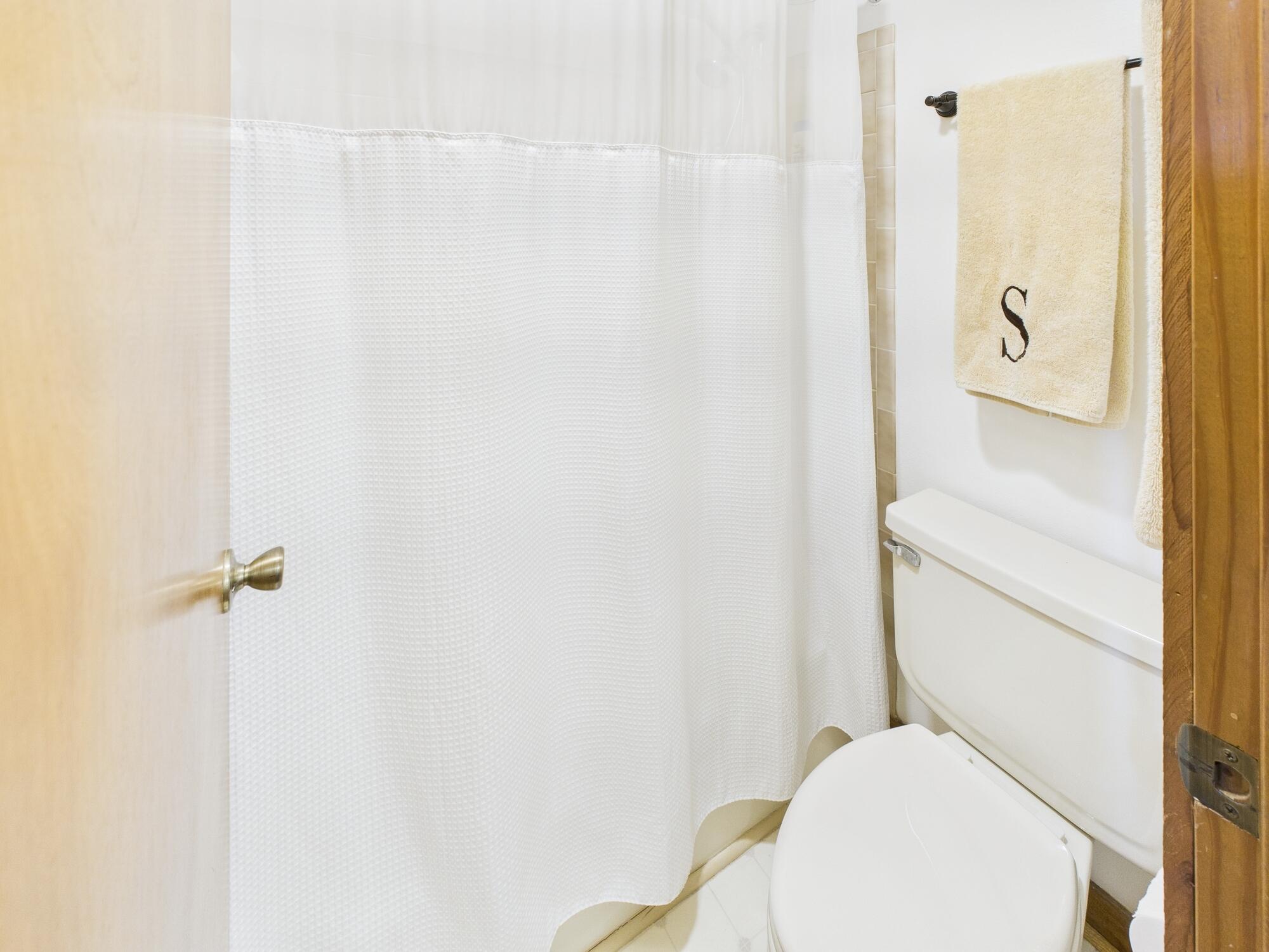 14266 Southwest 144th Parkway Okeechobee, FL 34974 - Photo 29 of 63 a white toilet sitting next to a shower curtain