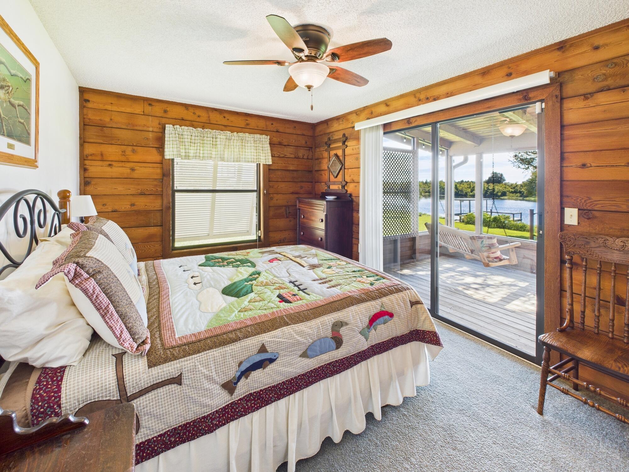 14266 Southwest 144th Parkway Okeechobee, FL 34974 - Photo 31 of 63 a bedroom with a bed and a large window with the outer view