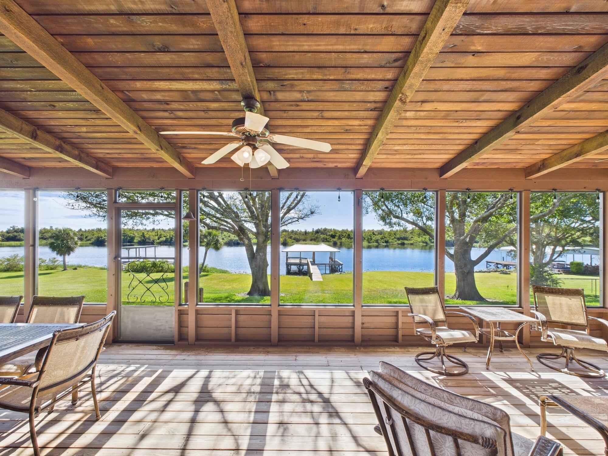 14266 Southwest 144th Parkway Okeechobee, FL 34974 - Photo 36 of 63 a view of a patio with a table and chairs under an umbrella