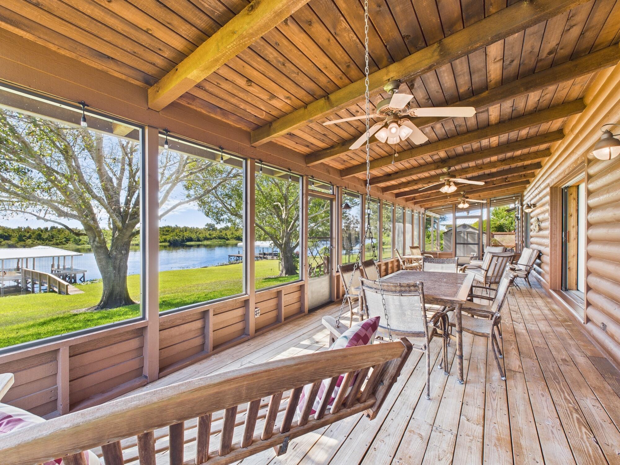 14266 Southwest 144th Parkway Okeechobee, FL 34974 - Photo 37 of 63 a roof deck with table and chairs and wooden floor