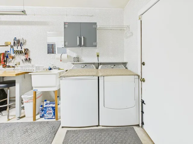 a view of a patio with table and chairs under an umbrella