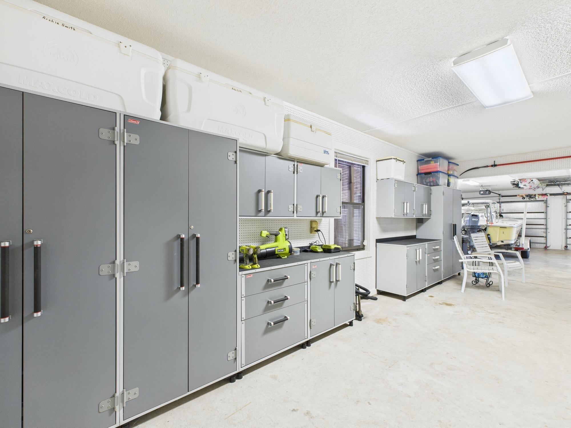 14266 Southwest 144th Parkway Okeechobee, FL 34974 - Photo 44 of 63 a kitchen with white cabinets and stainless steel appliances