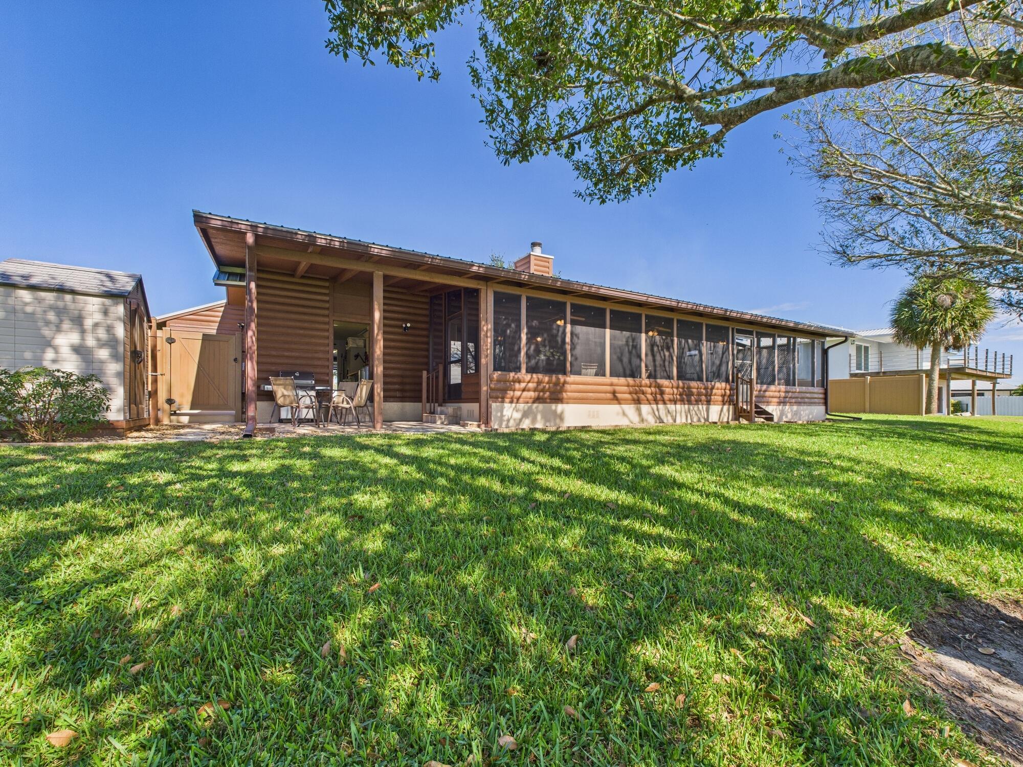 14266 Southwest 144th Parkway Okeechobee, FL 34974 - Photo 48 of 63 a view of a house with a yard porch and sitting area