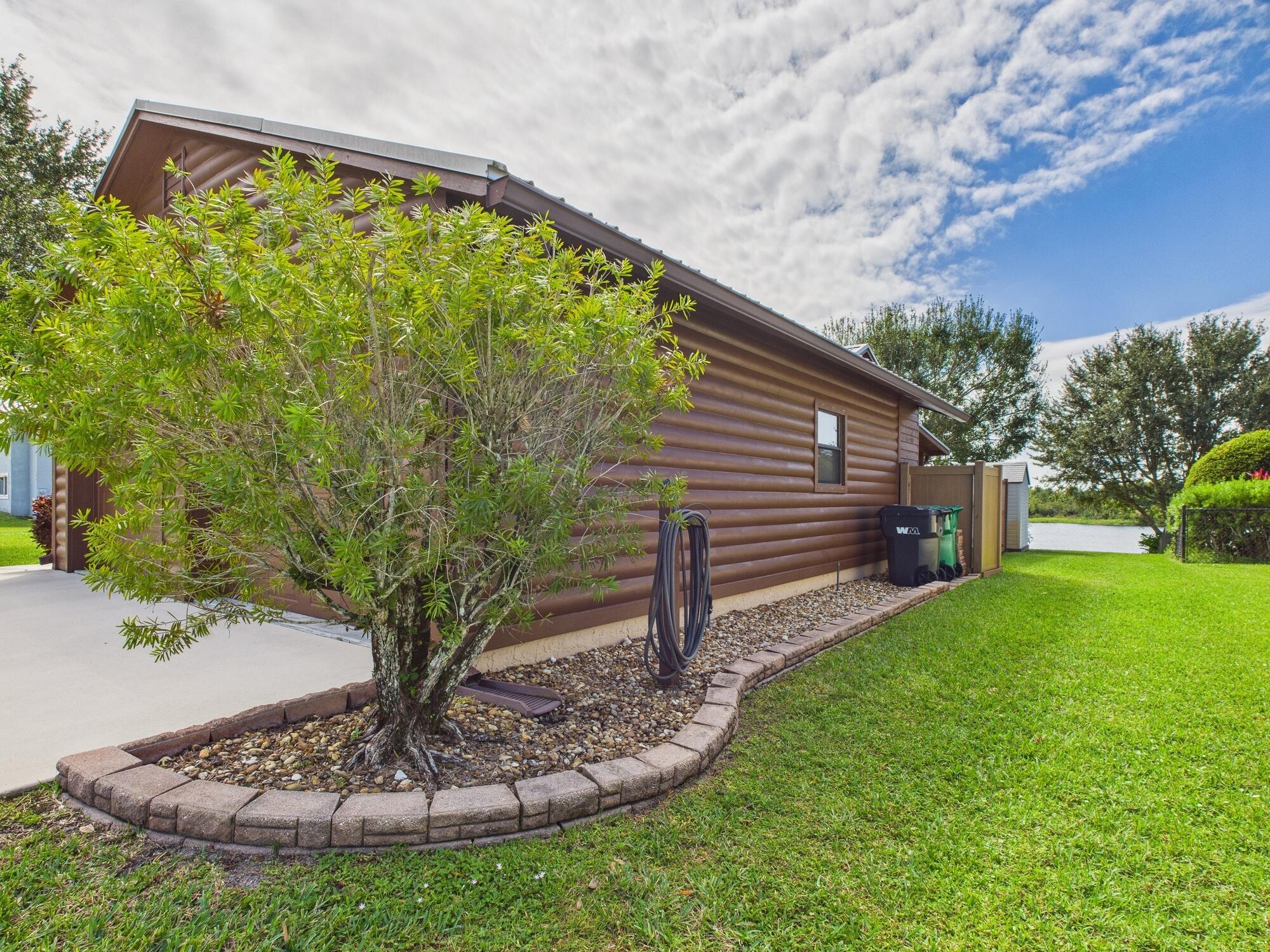 14266 Southwest 144th Parkway Okeechobee, FL 34974 - Photo 6 of 63 a view of a backyard with plants and a garden
