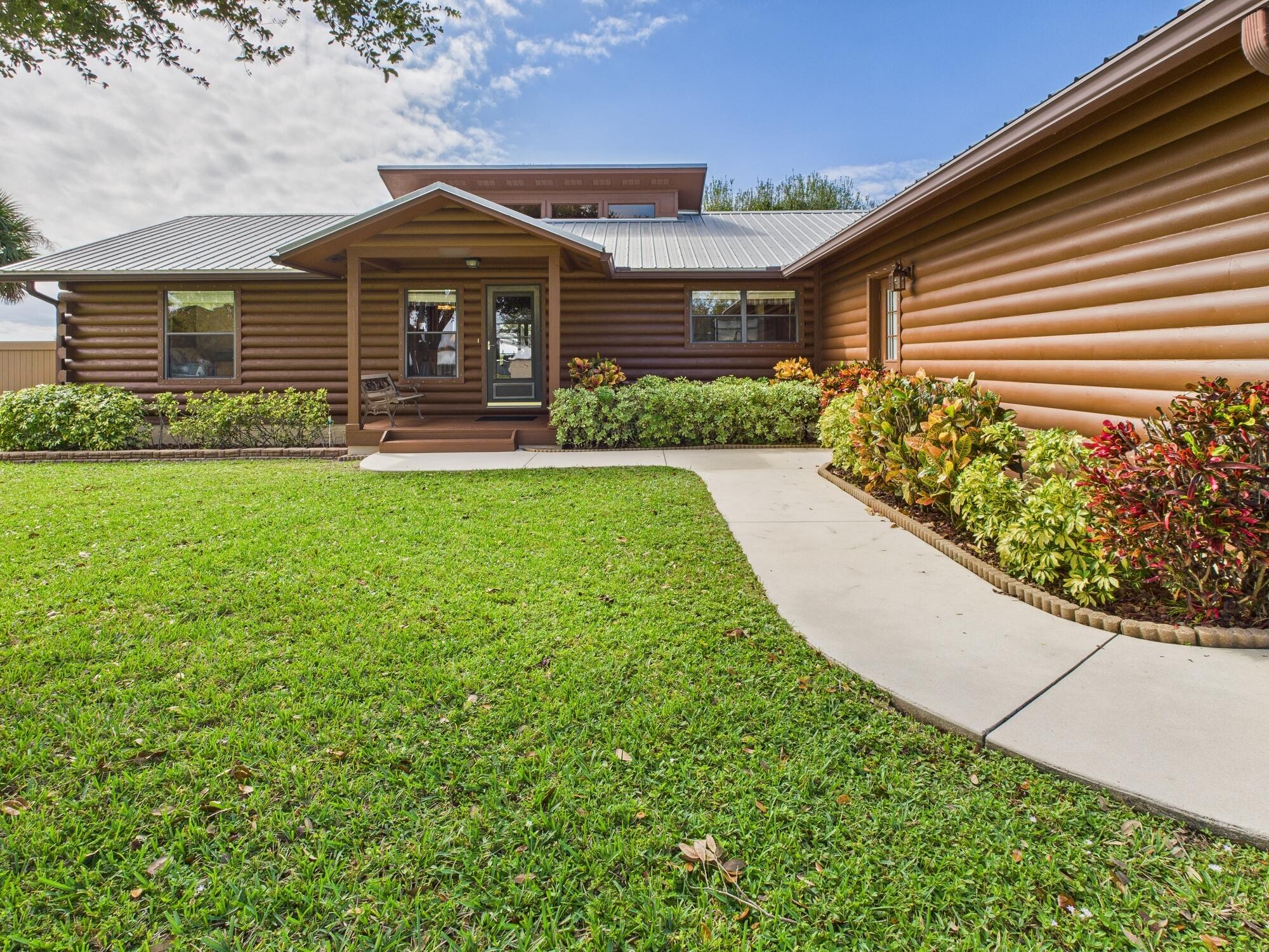 14266 Southwest 144th Parkway Okeechobee, FL 34974 - Photo 7 of 63 a front view of a house with garden