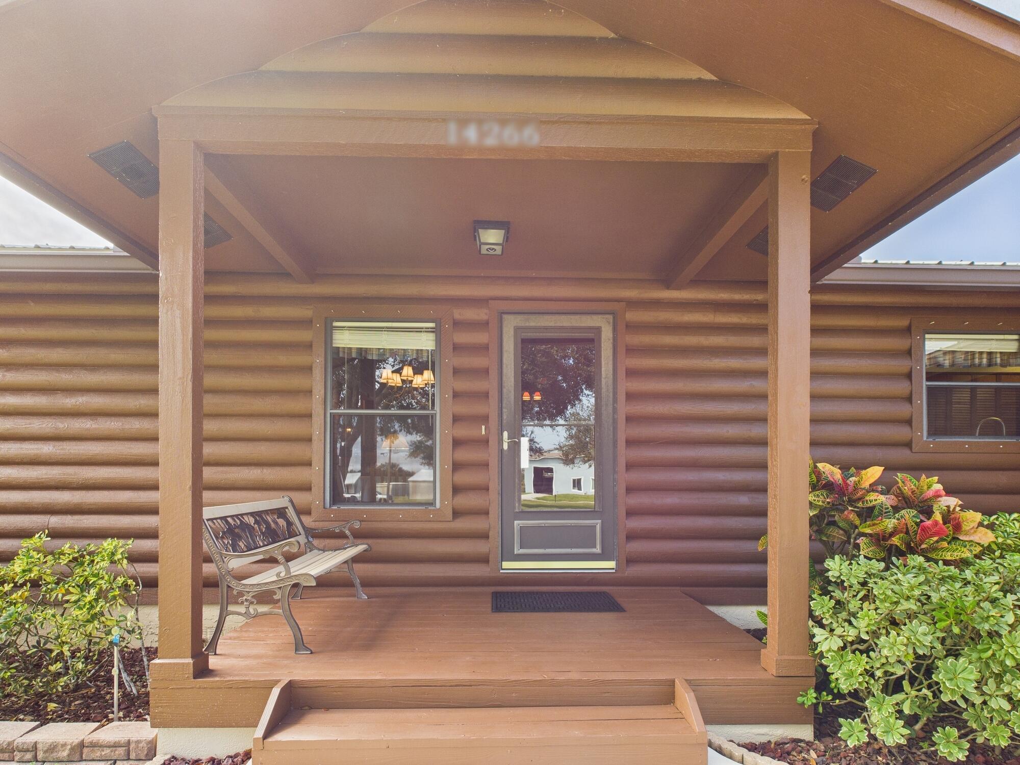 14266 Southwest 144th Parkway Okeechobee, FL 34974 - Photo 8 of 63 a front view of a house with a porch