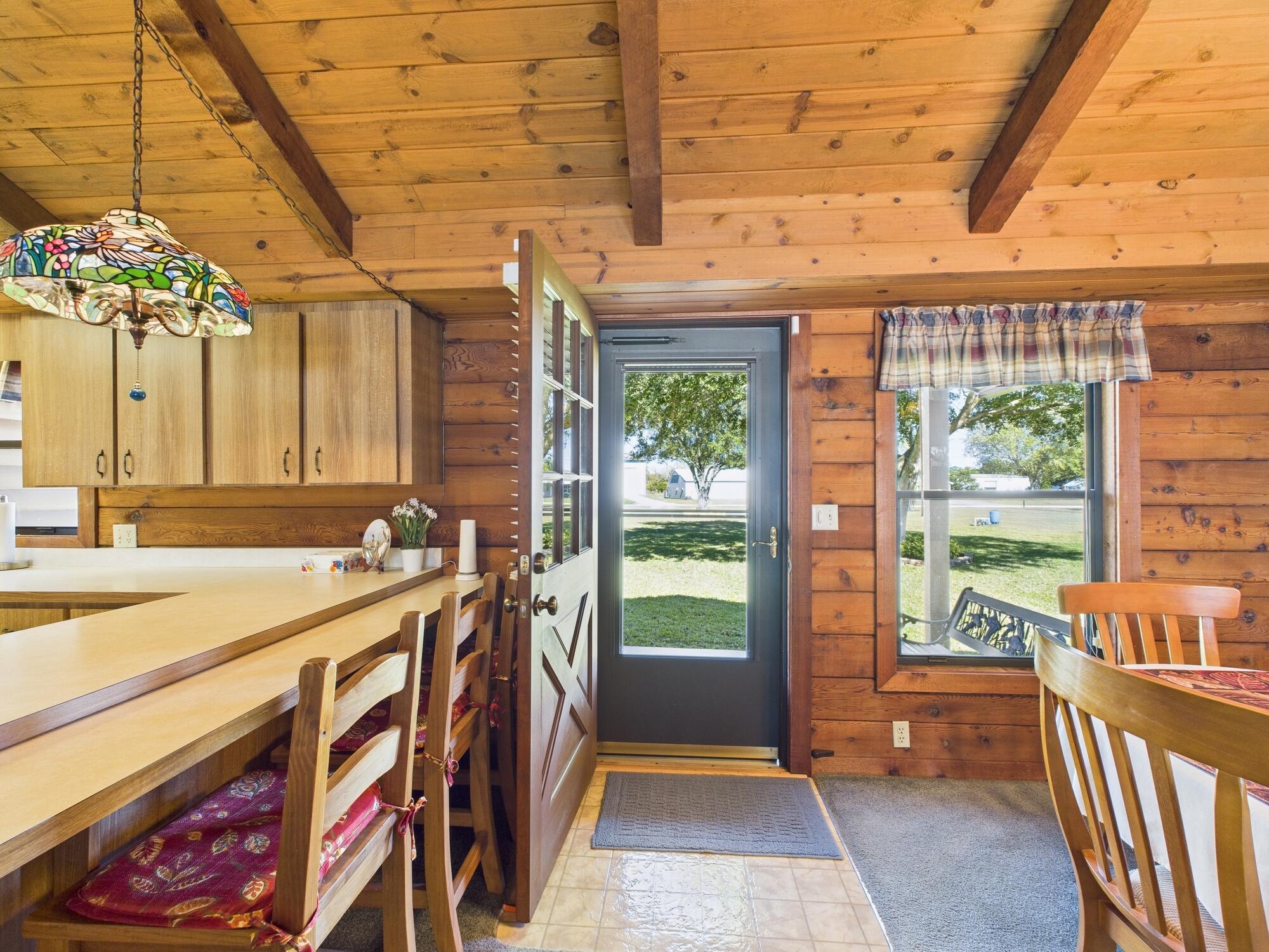 14266 Southwest 144th Parkway Okeechobee, FL 34974 - Photo 10 of 63 a view of a porch with a table and chairs