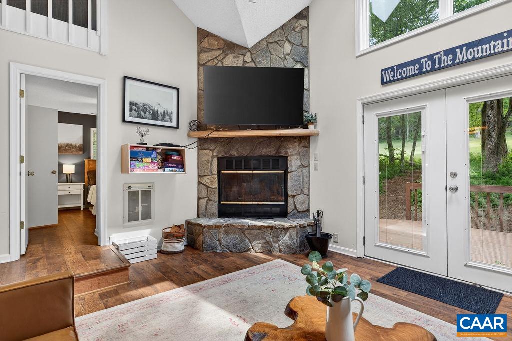 20 Blue Ridge Court Roseland, VA 22967 - Photo 10 of 56 A stone, wood-burning fireplace serves as the focal point of the open living area.