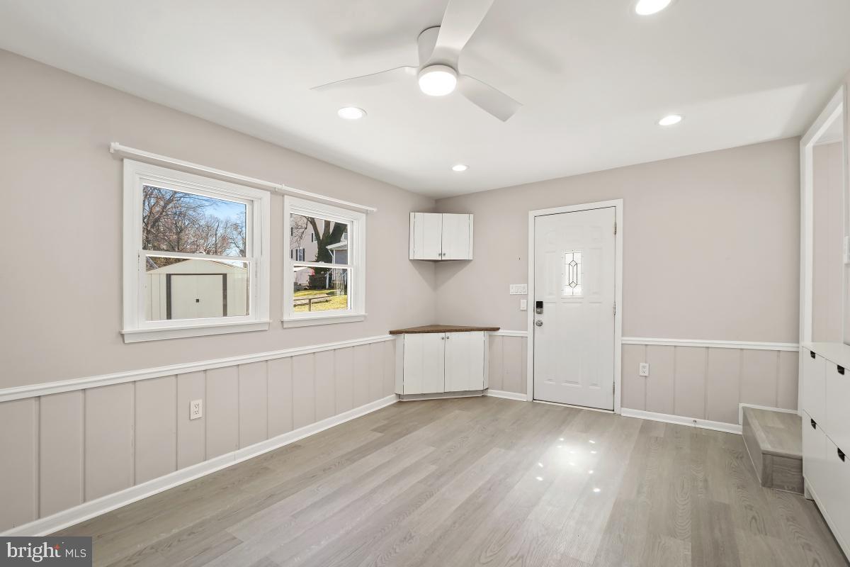 4213 Allison Circle Fairfax, VA 22030 - Photo 12 of 22 a large white kitchen with wooden floors and white walls