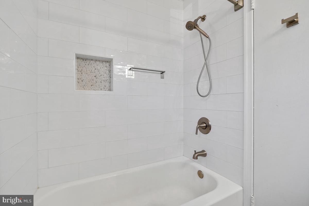 4213 Allison Circle Fairfax, VA 22030 - Photo 17 of 22 a bathroom with a bath tub with a shower