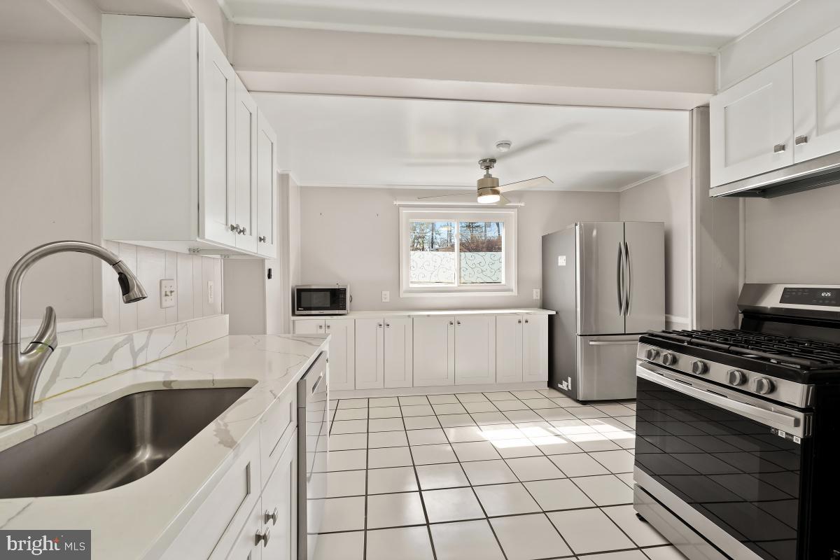 4213 Allison Circle Fairfax, VA 22030 - Photo 10 of 22 a kitchen with a sink a stove and cabinets