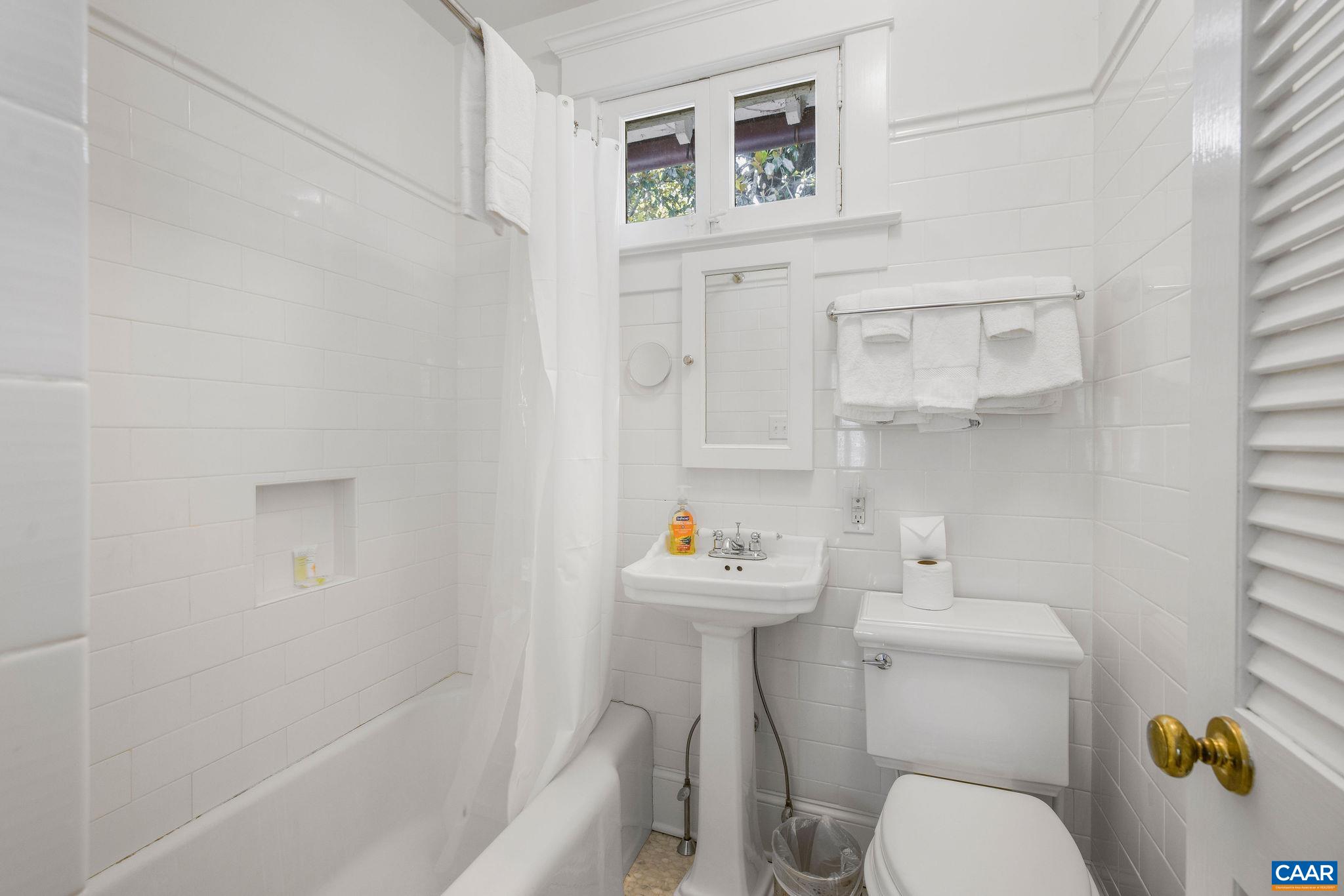 1204 Blue Ridge Road Charlottesville, VA 22903 - Photo 45 of 51 a white toilet sitting next to a bathroom sink