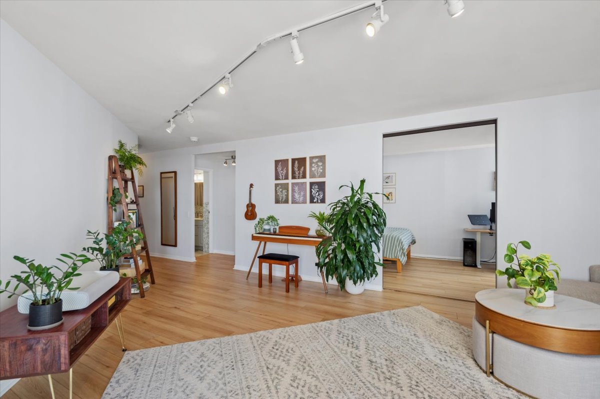 5320 North Sheridan Road, Unit 708 Chicago, IL 60640 - Photo 5 of 19 a living room with furniture potted plant and wooden floor