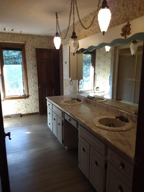 278 Holyoke Road Butler, PA 16001 - Photo 14 of 24 a bathroom with a granite countertop sink a large mirror and a shower