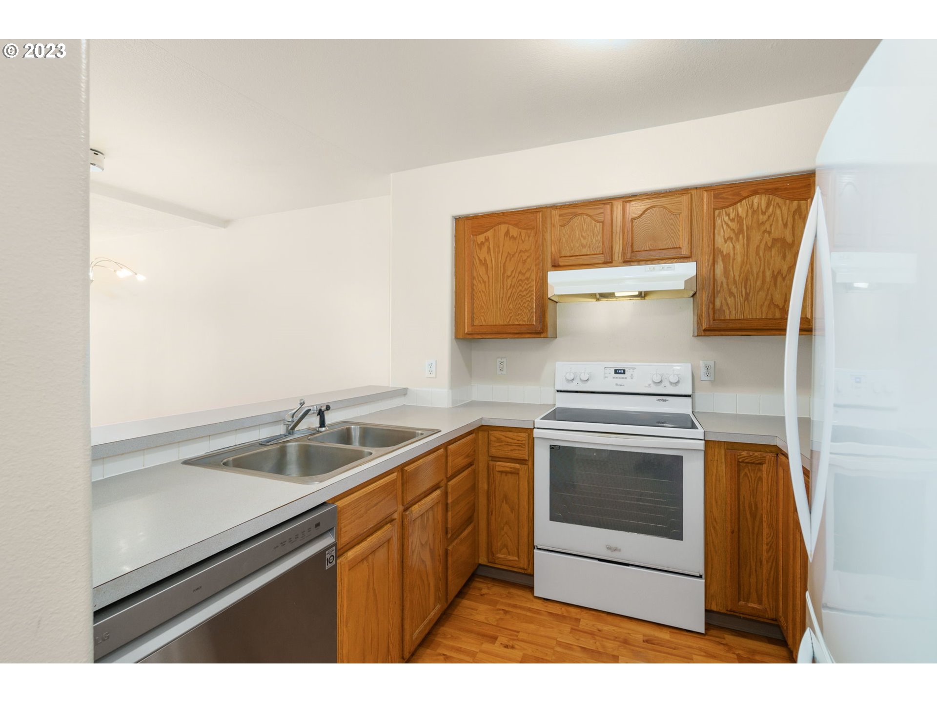 8342 Southeast Clinton Street Portland, OR 97266 - Photo 12 of 25 a kitchen with a sink cabinets and stainless steel appliances