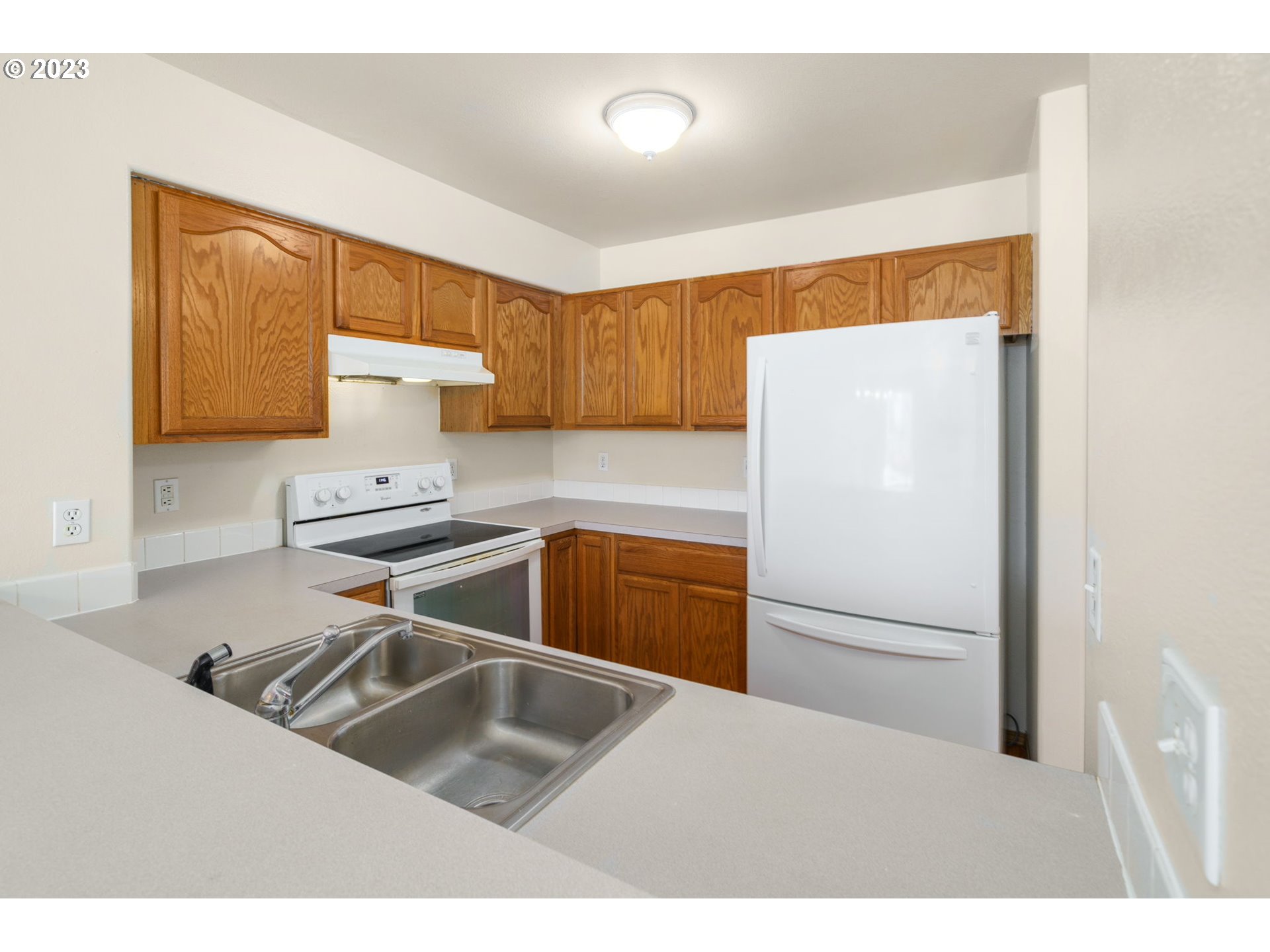 8342 Southeast Clinton Street Portland, OR 97266 - Photo 13 of 25 a kitchen with a refrigerator sink and stove