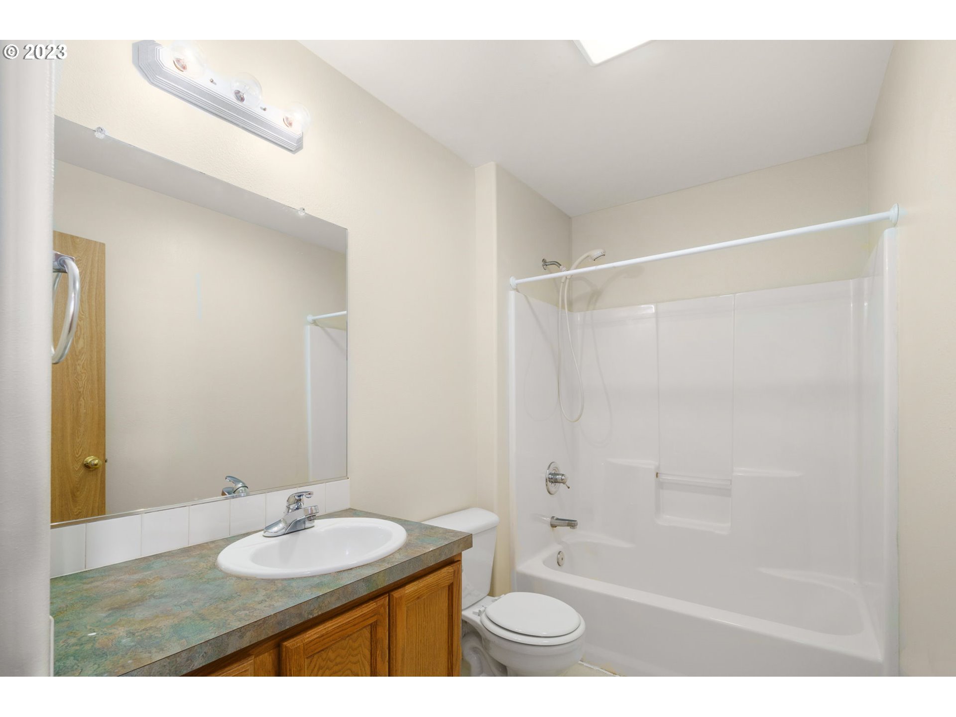 8342 Southeast Clinton Street Portland, OR 97266 - Photo 18 of 25 a bathroom with a granite countertop sink mirror and shower