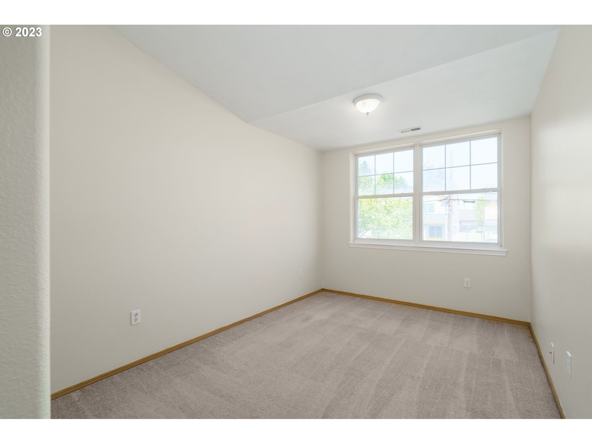 8342 Southeast Clinton Street Portland, OR 97266 - Photo 19 of 25 an empty room with wooden floor and windows