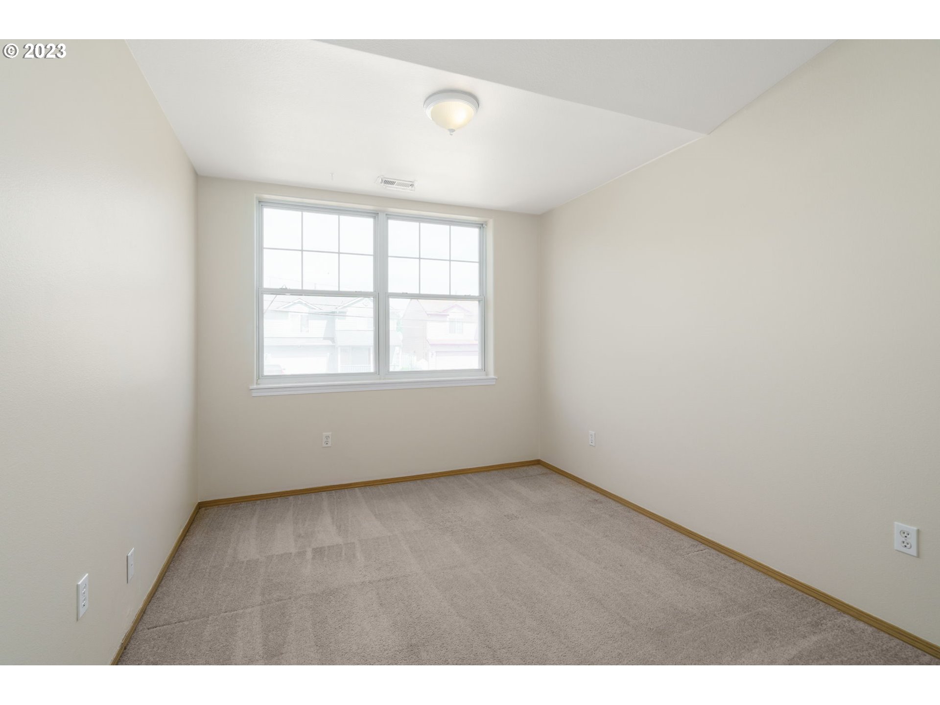 8342 Southeast Clinton Street Portland, OR 97266 - Photo 20 of 25 an empty room with wooden floor and windows