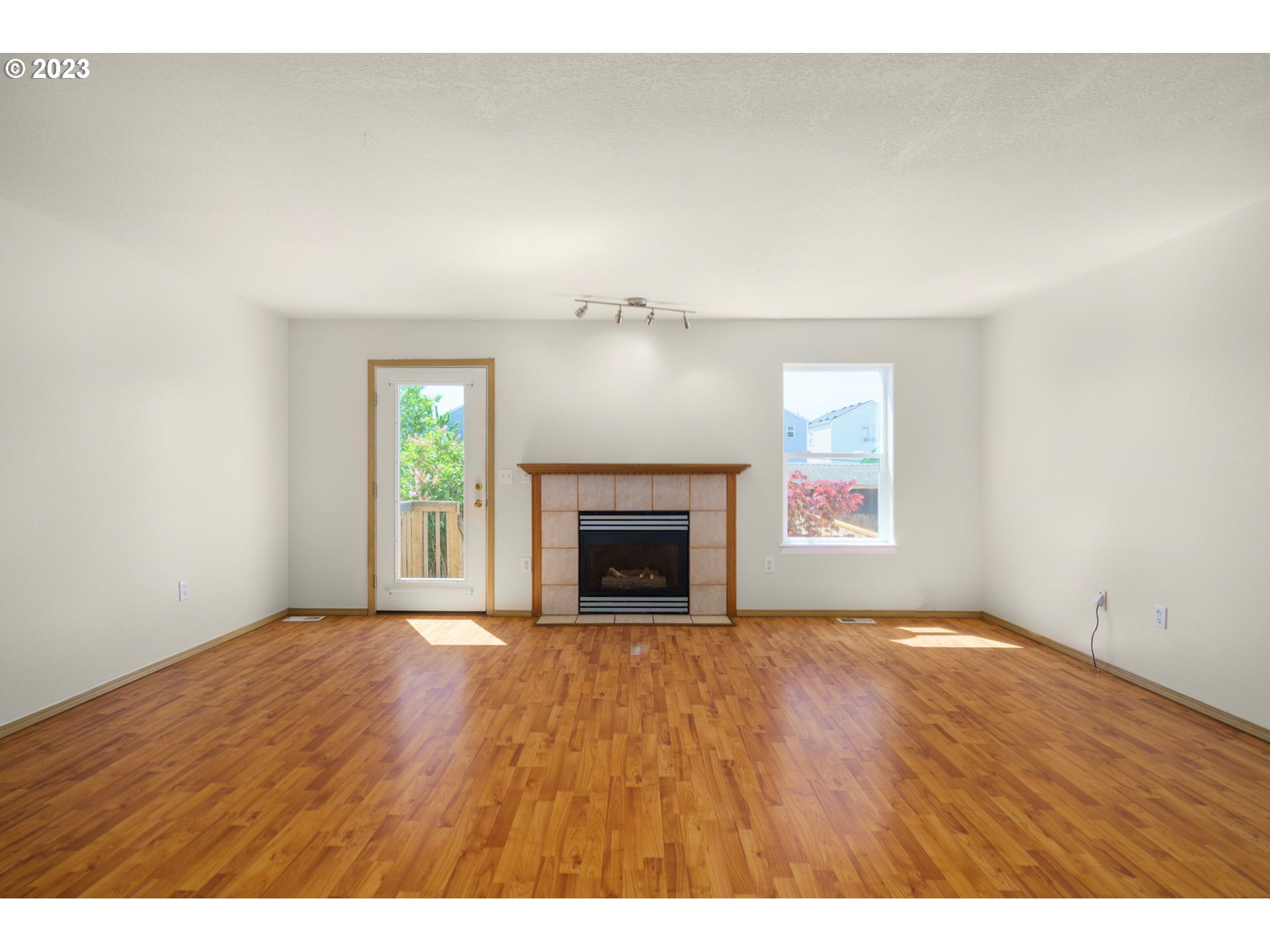 8342 Southeast Clinton Street Portland, OR 97266 - Photo 5 of 25 a view of an empty room with a fireplace and a window