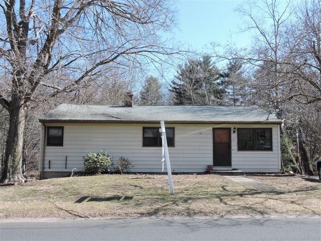 a house that has a tree in front of it